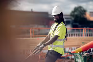 En byggarbetare som arbetar med verktyg på en byggarbetsplats