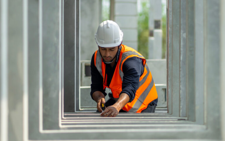 construction worker onsite measuring