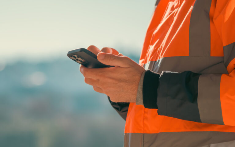 A construction worker using the fatigue management app on his phone