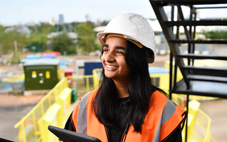 construction worker on site looking at msite dashboards