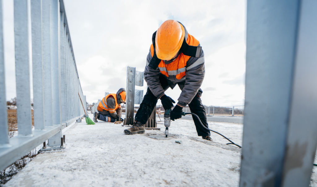 Construction worker drilling into the floor